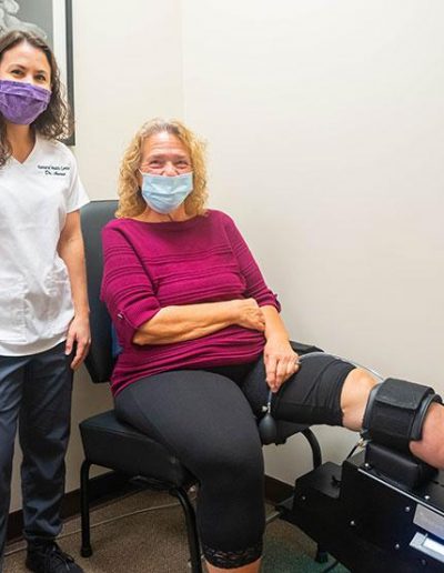 Dr Kayla with a client who suffers from knee pain.